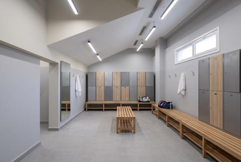 Changing room with lockers and wooden benches at Sharm Sports Club